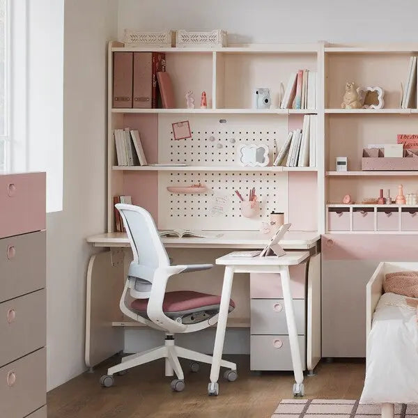 Iloom Linki Plus Smart Desk+ 1200W 4-Story Bookshelf in pink/white with desk pad; chair wheels roll under the organized study setup.
