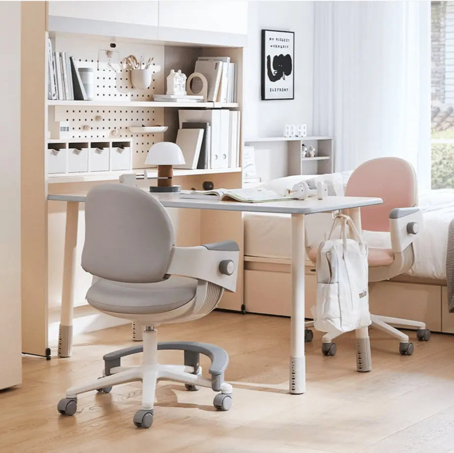 Iloom Ringo I Chair with footrest, gray seat, white frame; fixed caster wheels roll on a bright study floor.