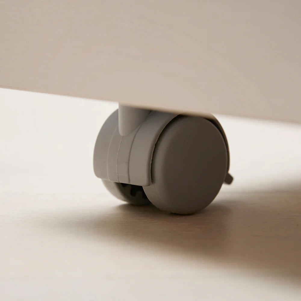 Iloom Roy Mono desk drawer with grey caster wheel under a light wood leg