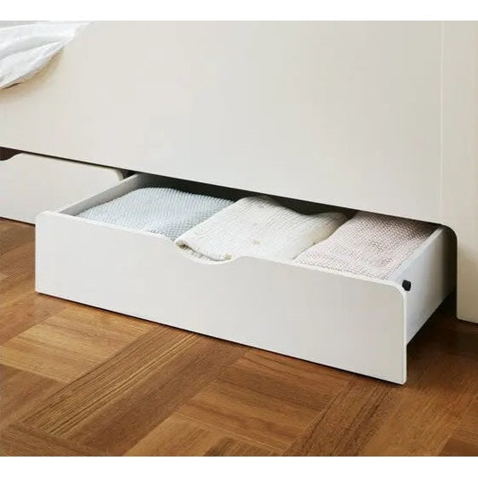 ILoom Tinkle Pop 1 Story Bed in white, with an open under-bed drawer storing folded pastel blankets.