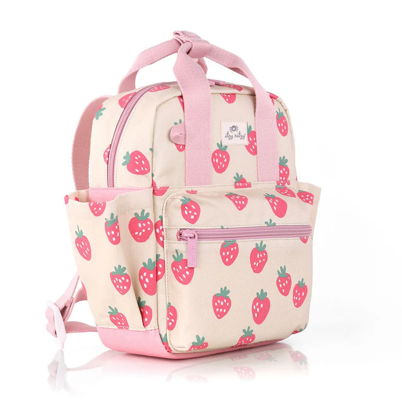 Itzy Ritzy Backpack in cream with pink strawberry print and pink straps, front zip pocket.