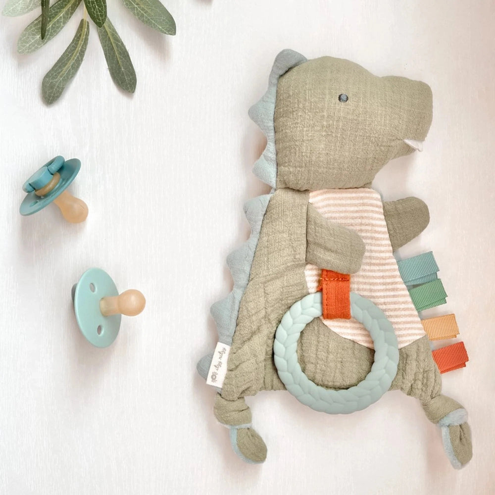 Itzy Ritzy Bitzy Crinkle sensory toy with teether dinosaur plush, pastel gray/teal, braided ring