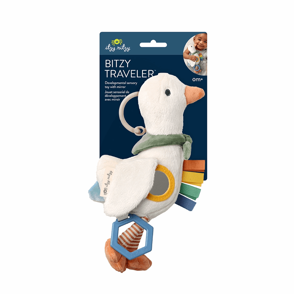 Itzy Ritzy Bitzy Traveler plush baby toy with mirror, green scarf, and multicolor ribbon tags