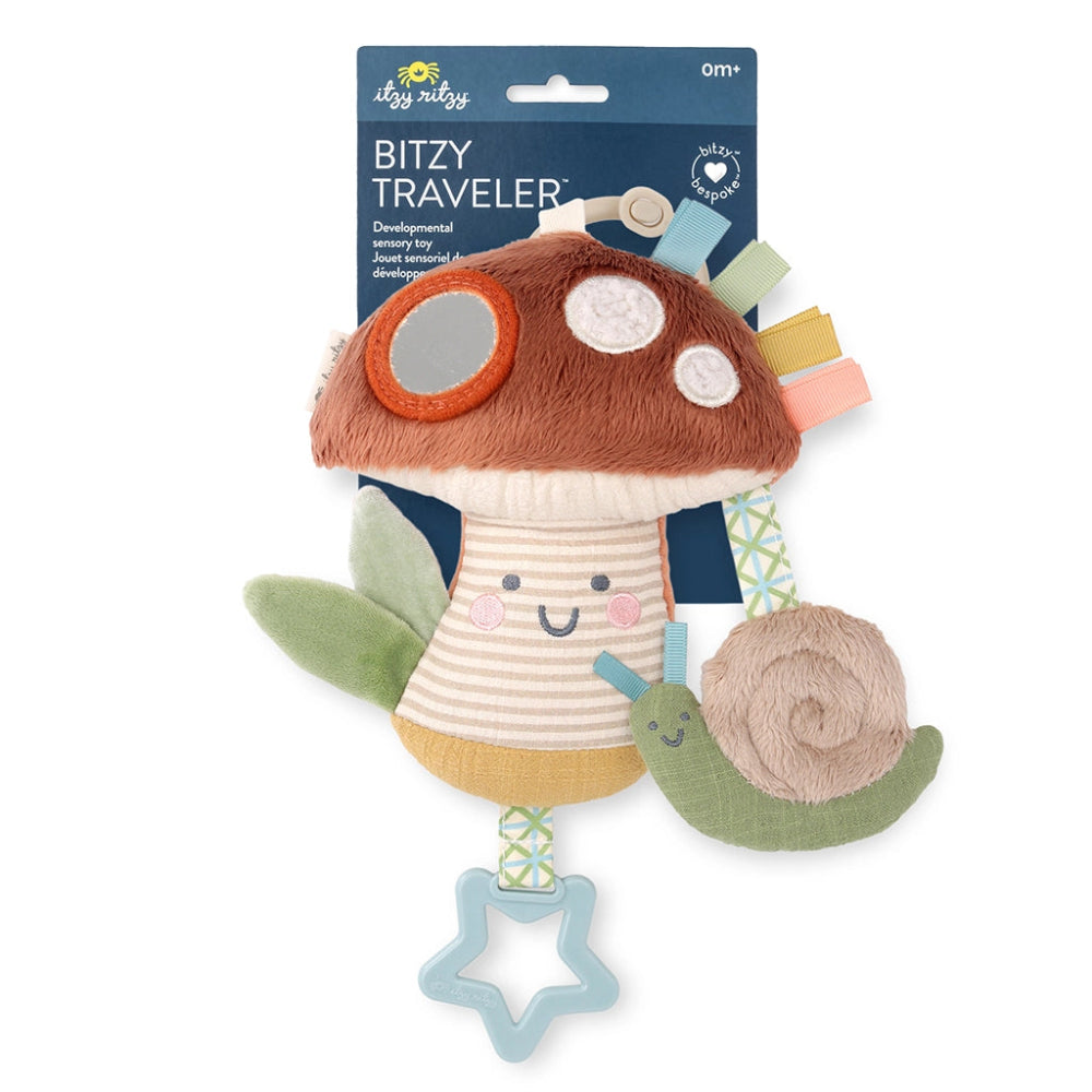 Bitzy Traveler plush mushroom toy, brown cap with pastel ribbon tags and blue star teether