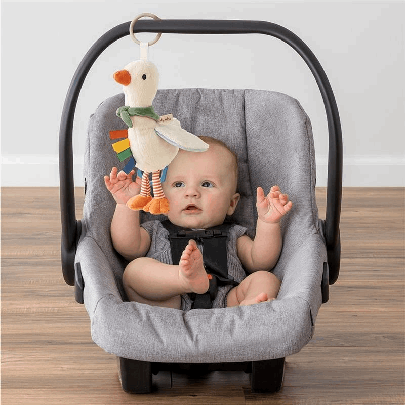 Itzy Ritzy Bitzy Traveler baby car-seat toy with a hanging plush duck ornament