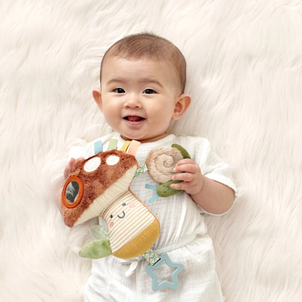 Itzy Ritzy Bitzy Traveler baby toy; soft plush rattle with colorful ribbons and star attachment