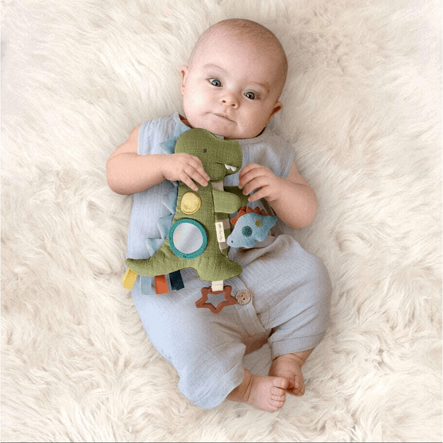 Itzy Ritzy Bitzy Traveler baby activity toy; green plush with colorful shapes and hanging elements