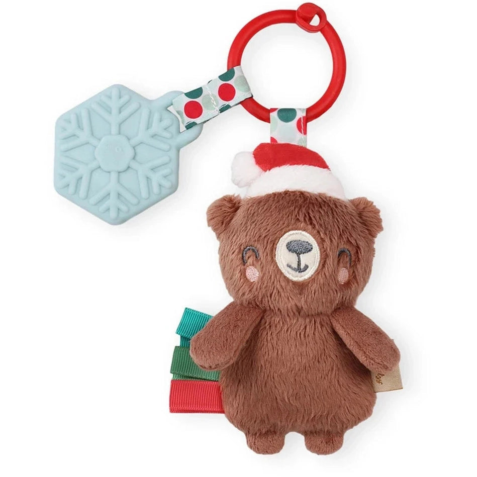 Itzy Ritzy Holiday Itzy Pal Plush Teether: brown bear with Santa hat, red ring and snowflake silicone teether dangling.