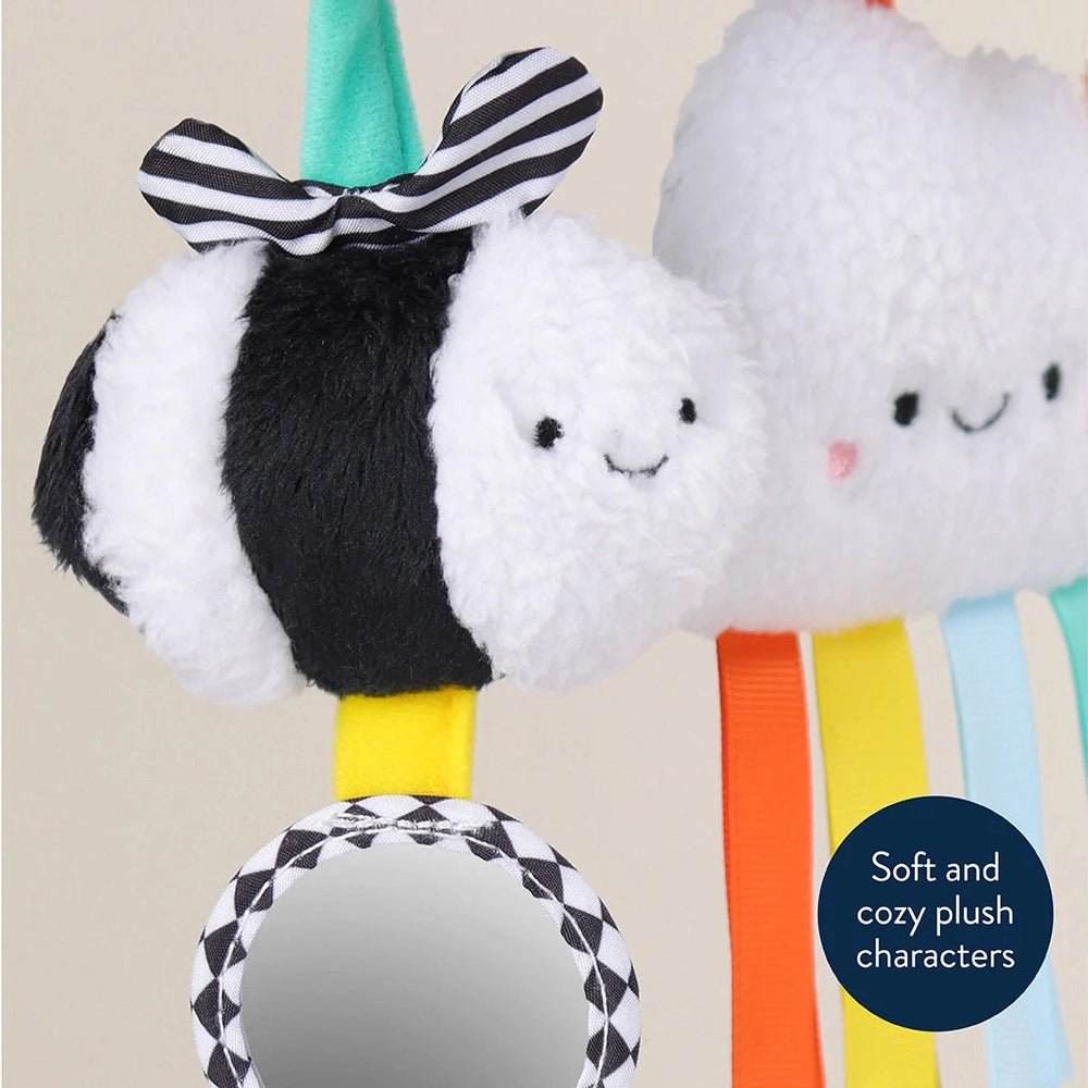 Itzy Ritzy Itzy Bitzy Spiral Car Seat Activity Toy featuring soft plush clouds, striped bow, and rainbow ribbons