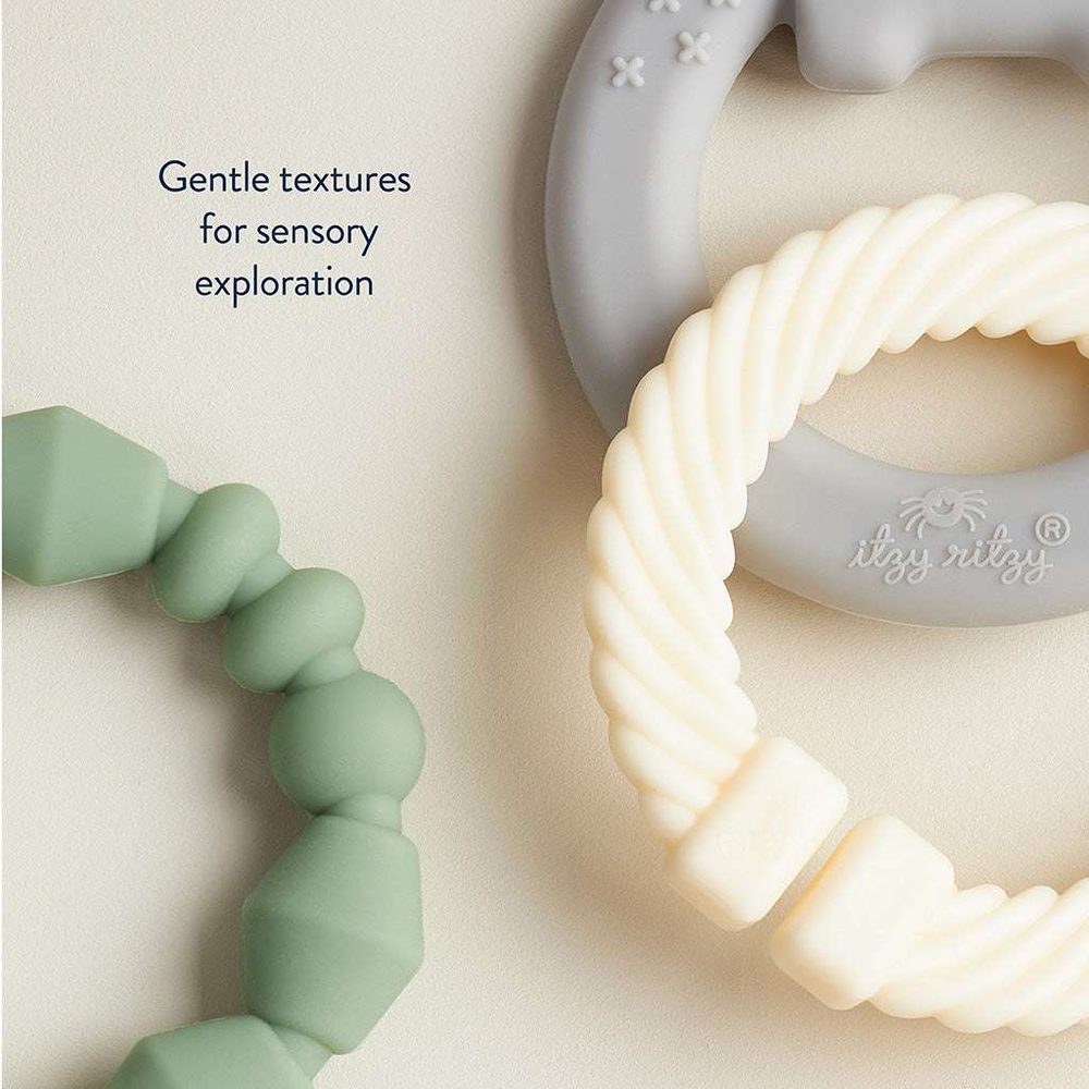 Itzy Ritzy Itzy Loops teething toy set with green silicone bead loop and cream braided rope ring