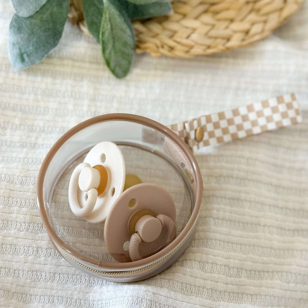 Itzy Ritzy Paci Case in beige with tan zipper and two cream pacifiers inside