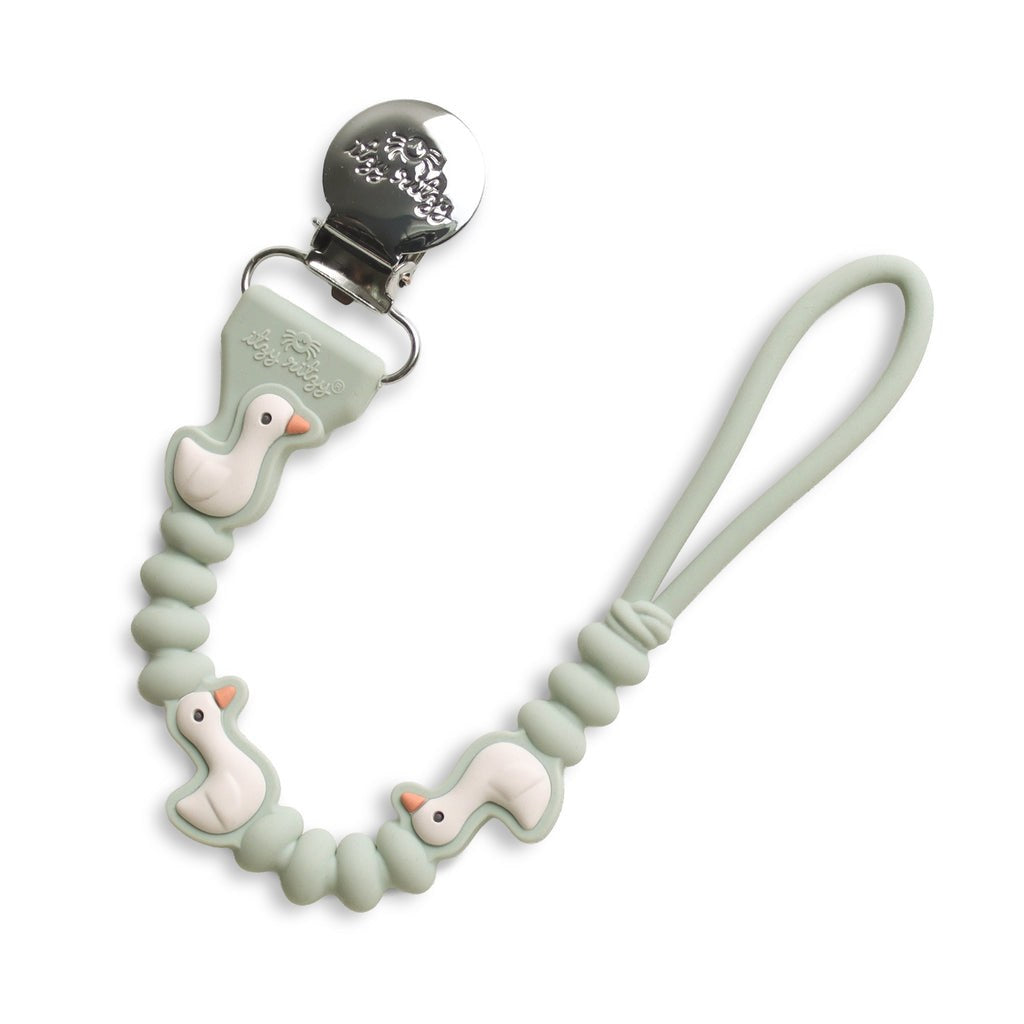 Itzy Ritzy Paci Strap Plus Goose in sage silicone with metal clothing clip and pacifier loop