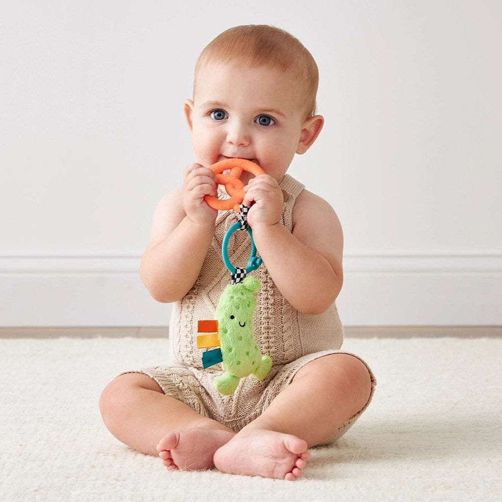 Itzy Ritzy Itzy Pal Parker The Pickle teething toy with orange ring and green plush pickle