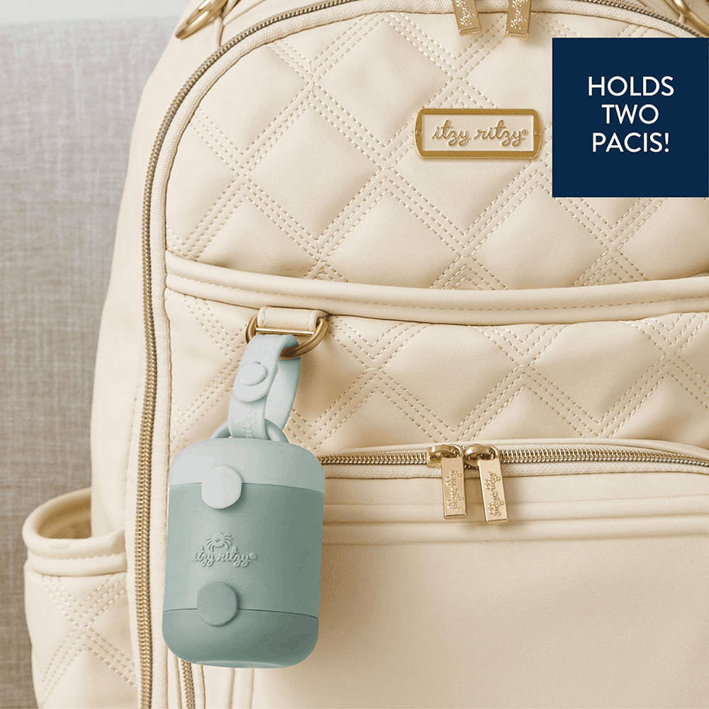 Itzy Ritzy Itzy Pod Duo pacifier/storage case in aqua attached to a beige quilted backpack with gold hardware