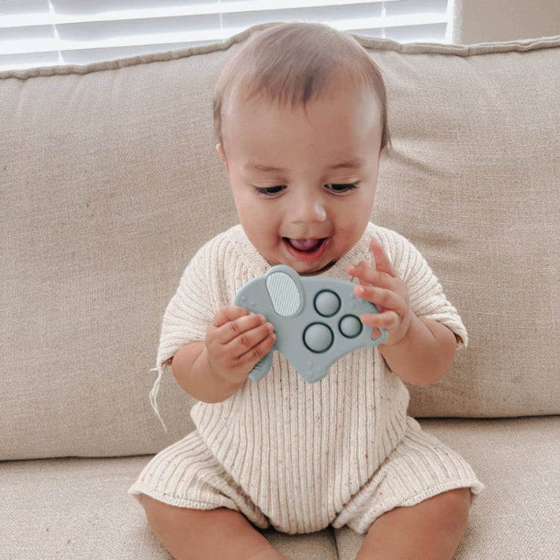 Itzy Ritzy Itzy Pop teether toy in light gray with round grip buttons