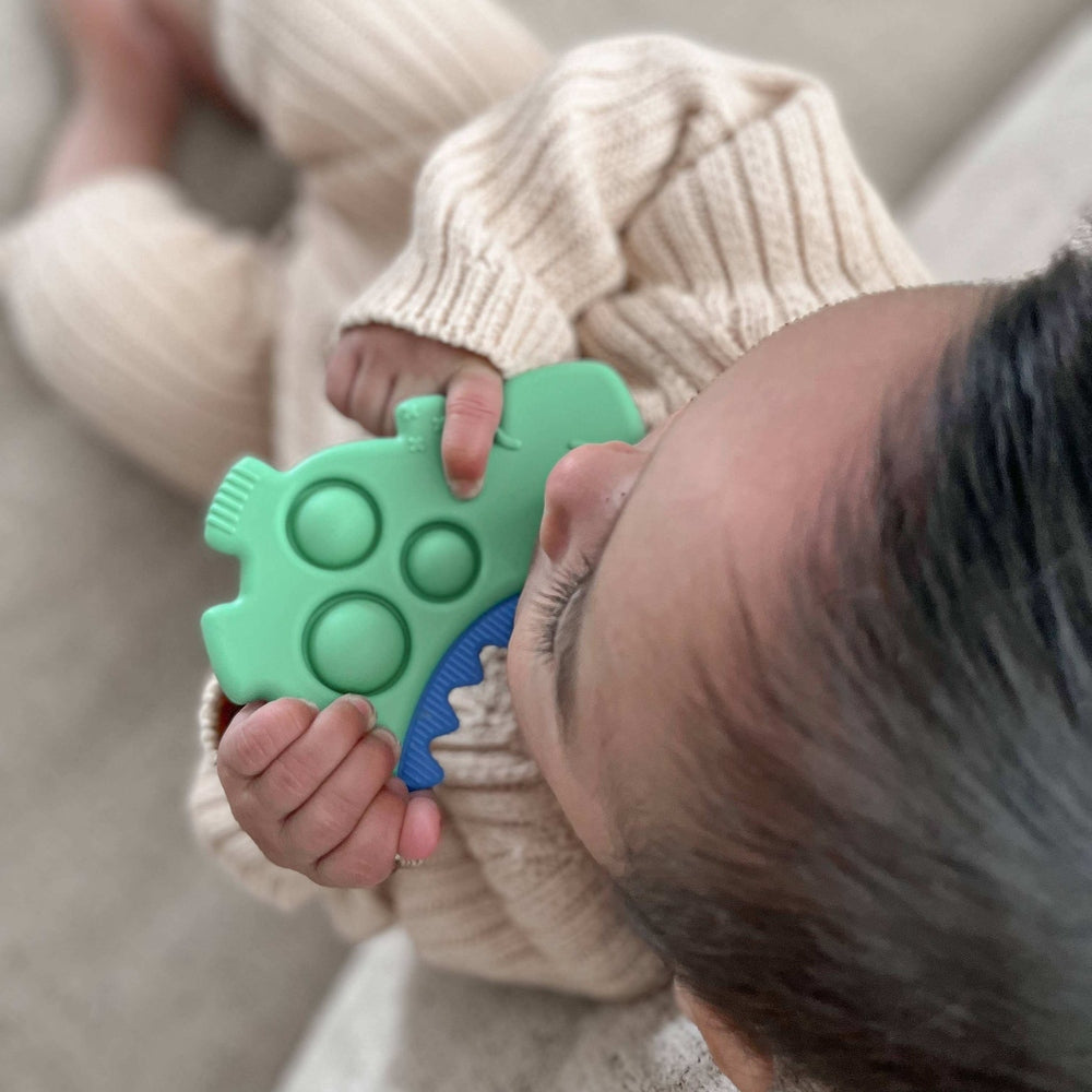 Itzy Ritzy Itzy Pop silicone teether in mint green with blue grip for baby

