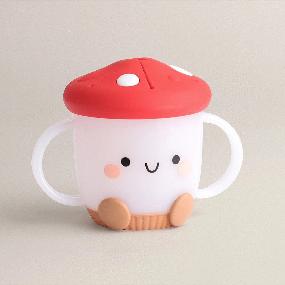 Itzy Ritzy Itzy Snack Cup with red lid and white body, dual handles, cute smiling face.