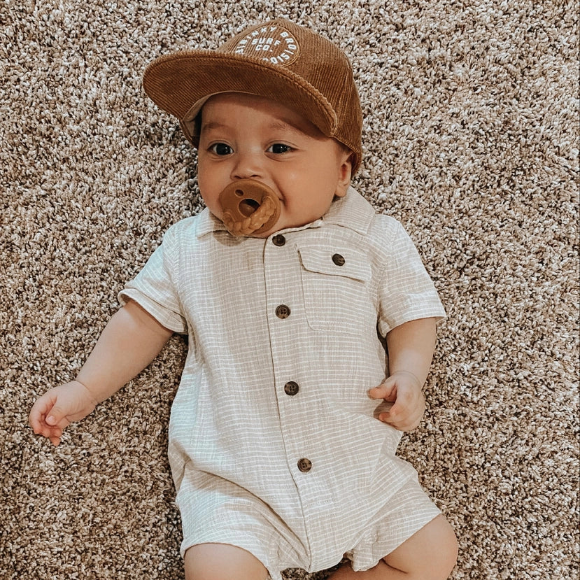 Itzy Ritzy Itzy Soother Natural Rubber Pacifier Sets (6–18M) baby lying on carpet with natural rubber pacifier in mouth