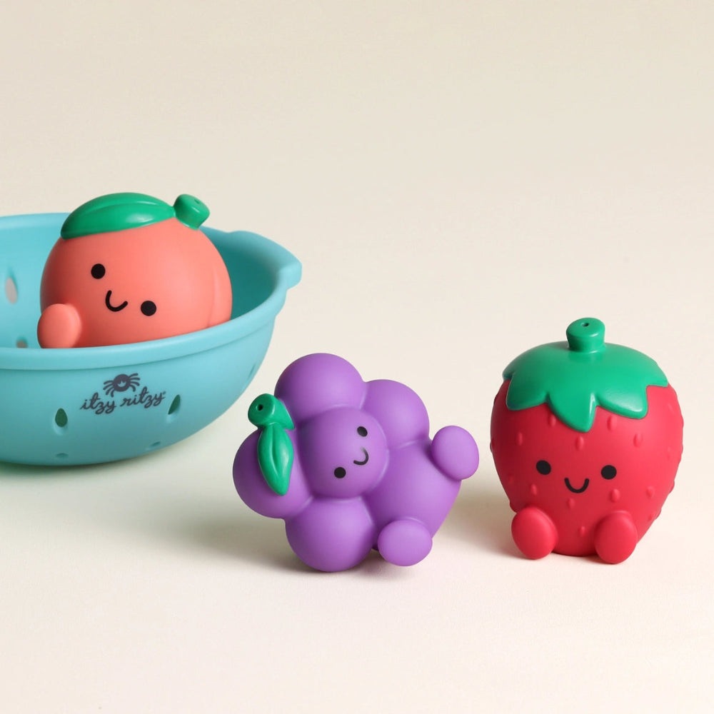Itzy Ritzy Itzy Splash Pals bath toys: three colorful fruit figures with a blue tub