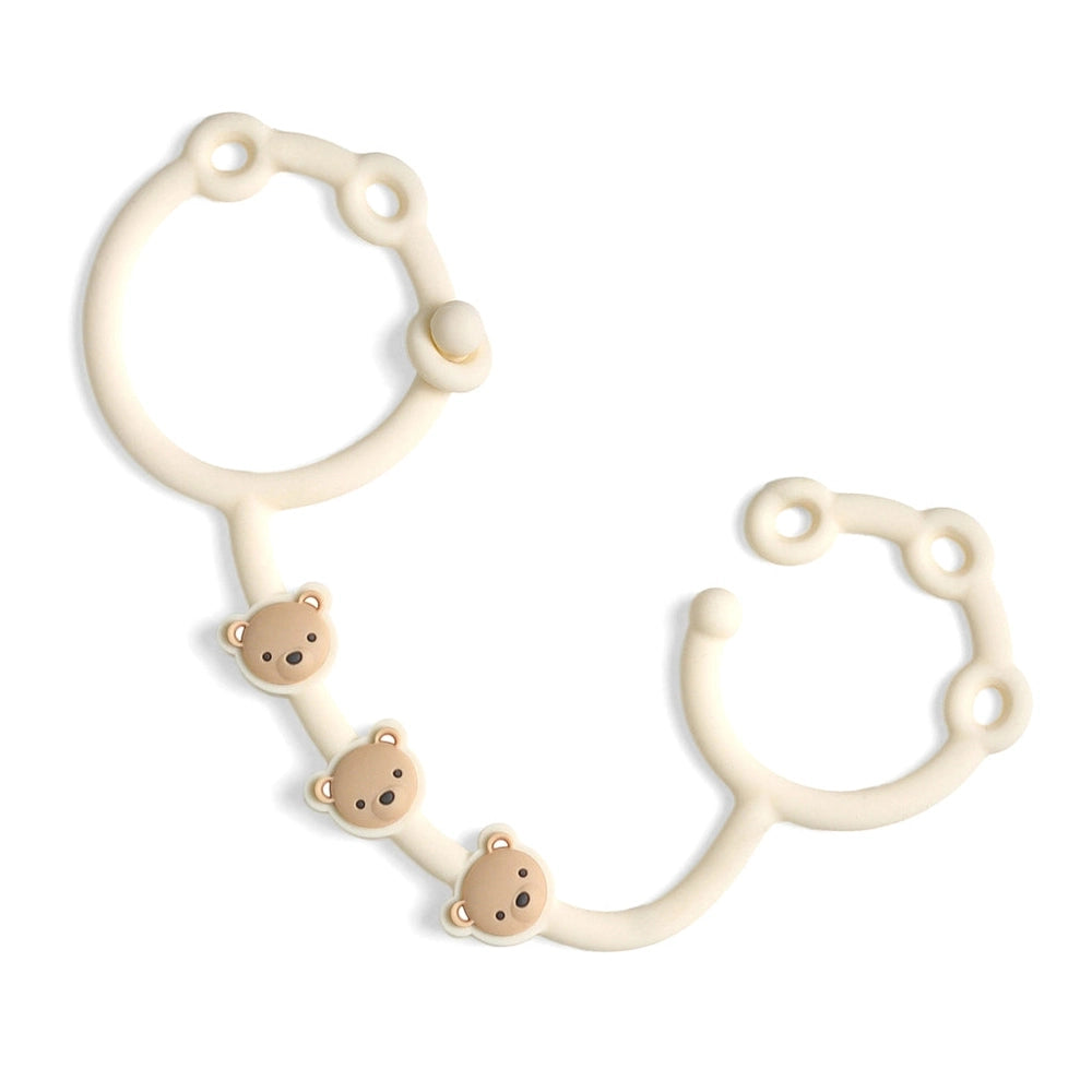 Itzy Ritzy Itzy Strap teething toy with cream silicone cord and three beige bear charms