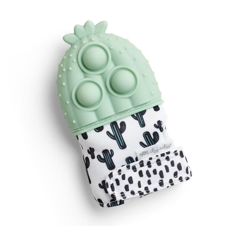 Itzy Ritzy Mitt Pop teething mitten in mint green silicone with cactus-pattern fabric sleeve; soothing gums as baby chews.