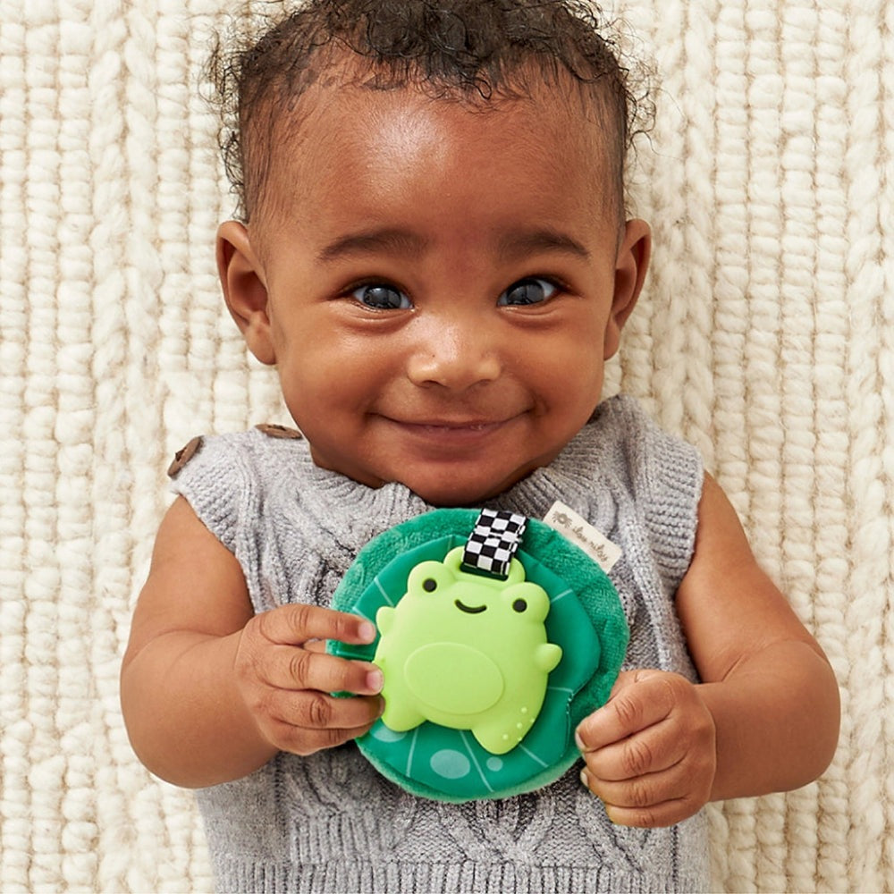 Itzy Ritzy Sweetie Crinkle Sensory Teether with green frog on teal base and checkered strap