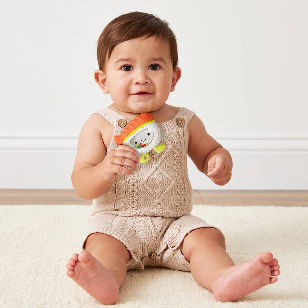 Itzy Ritzy Sweetie Shake Plus Rattle & Teether in beige knit; baby holding the soft toy