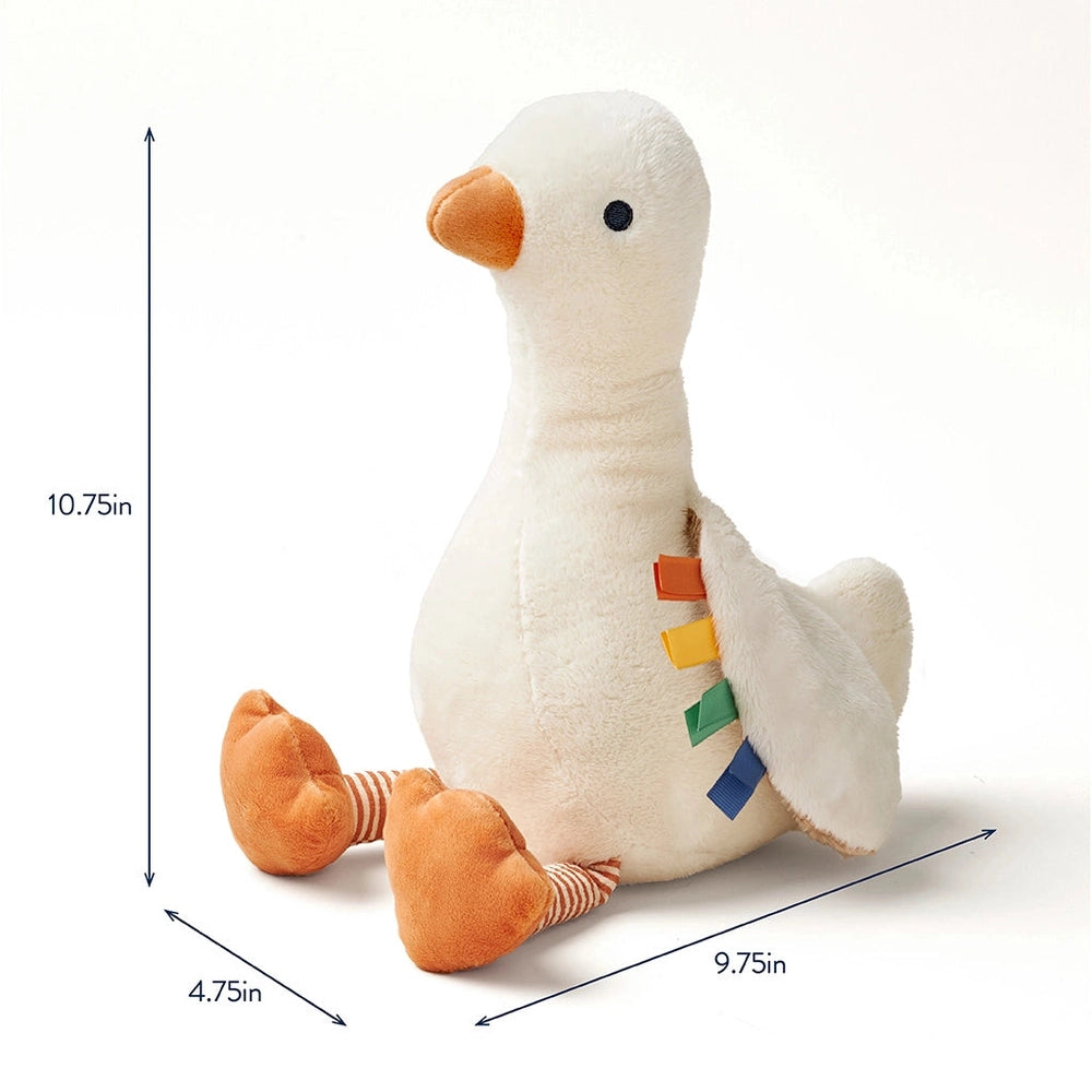 Itzy Ritzy Sweetie Snuggles Plush duck stuffed toy, white with orange beak and colorful ribbon tags, sits upright.