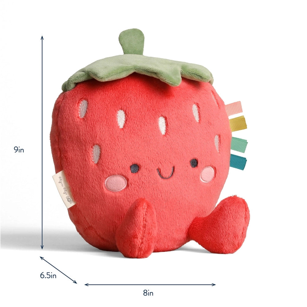 Itzy Ritzy Sweetie Snuggles Plush strawberry toy, soft red fabric with a green leaf, 9in tall, sits upright with colorful tags.