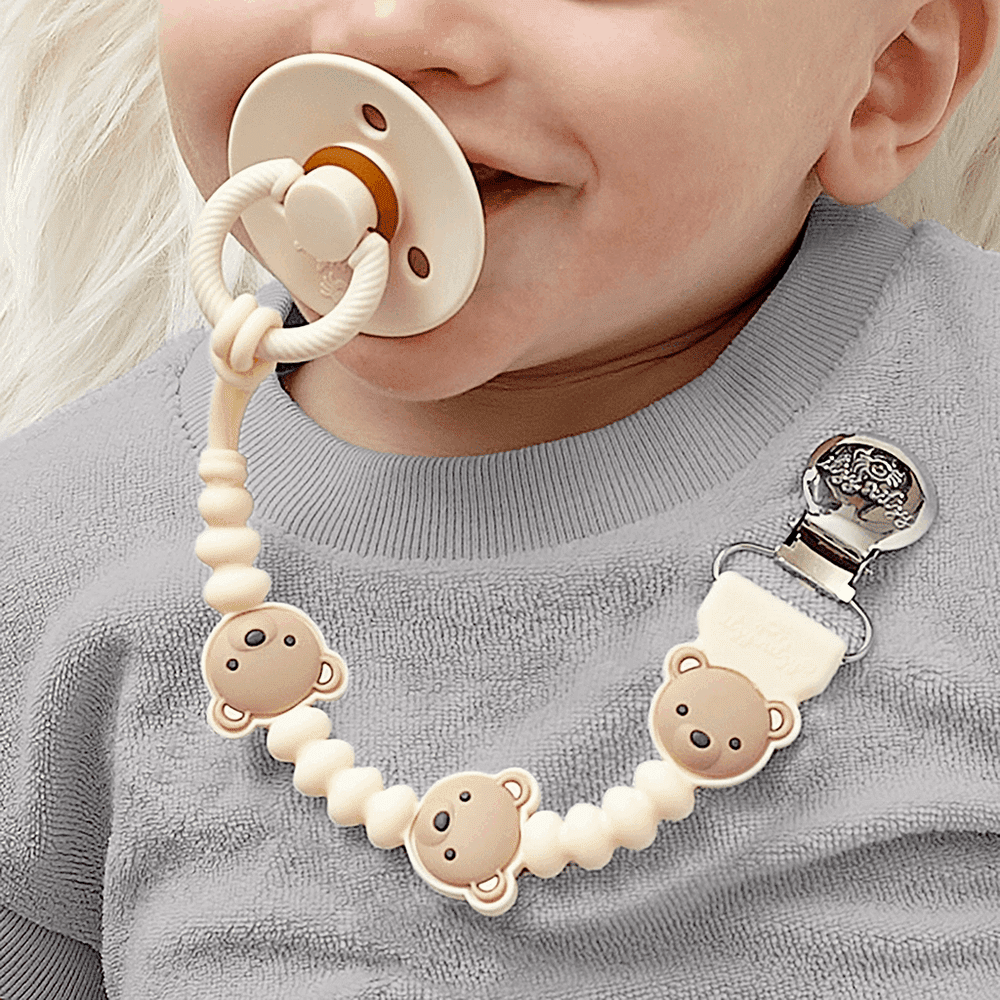 Itzy Ritzy Sweetie Strap Plus pacifier clip with cream beads and three monkey charms