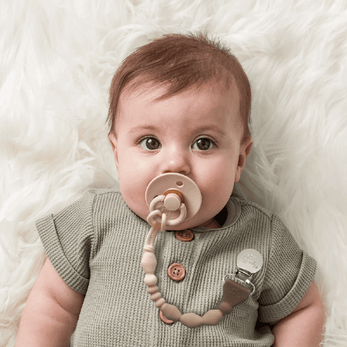 Itzy Ritzy Sweetie Strap Plus pacifier clip with beige beads on a neutral strap for baby