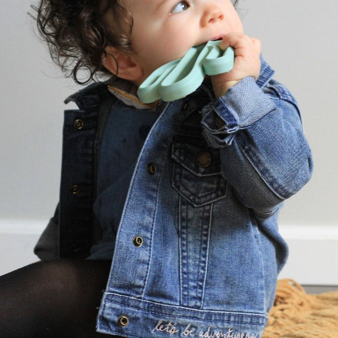 Itzy Ritzy teething mitt and teether gift set; mint green teether with baby in denim jacket