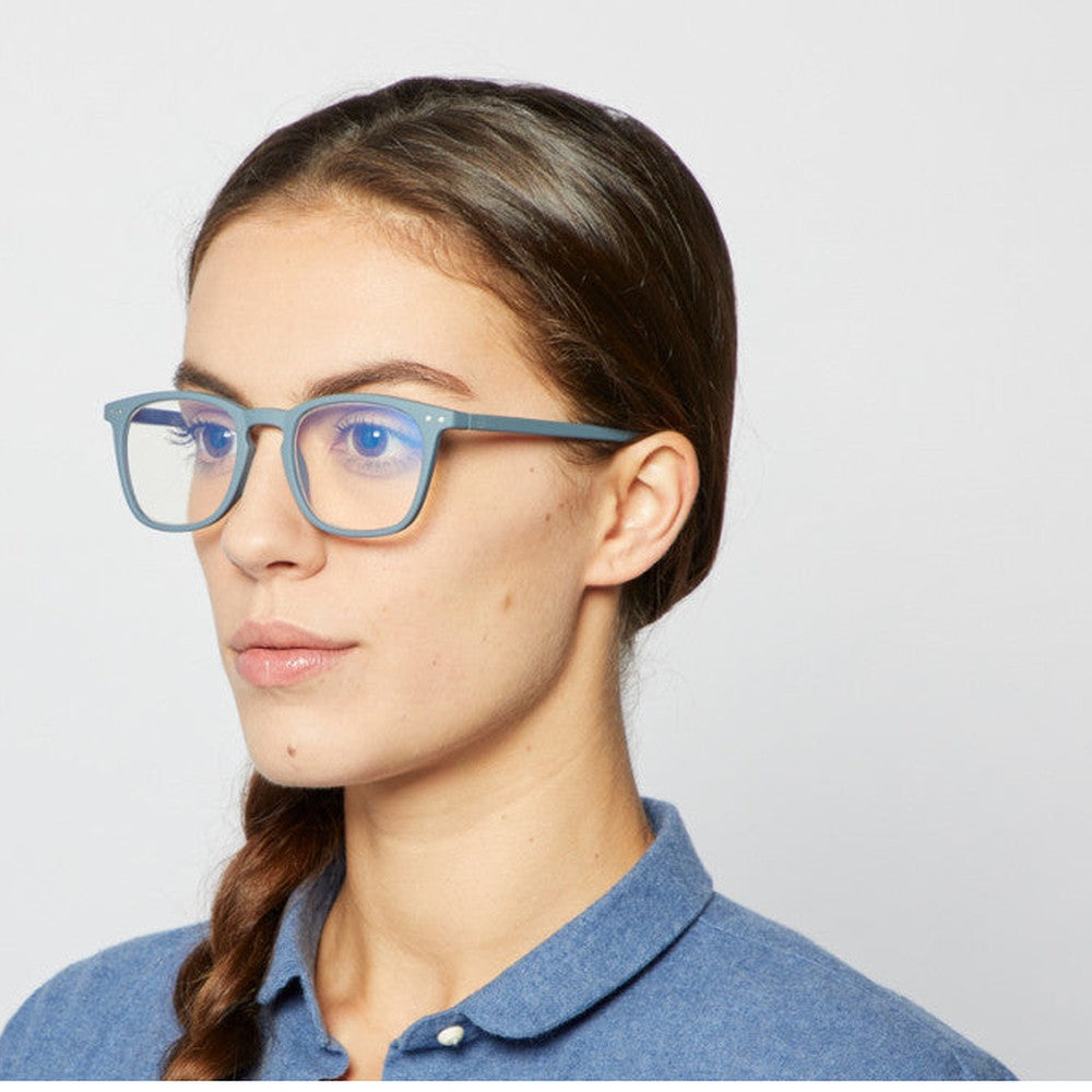 Izipizi Screen Adult #E Grey eyeglasses on a woman in a blue shirt.