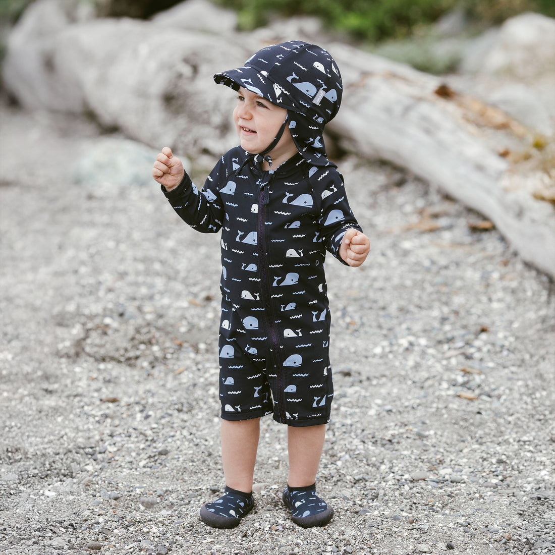 Jan & Jul UV Baby Cap - UV Quick Dry - Navy Whale Tales baby full-body outdoor lifestyle view