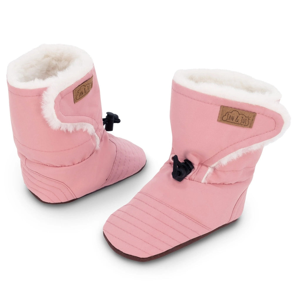 Jan & Jul Baby Stay-Put Winter Booties in dusty pink with white faux-fur lining, adjustable toggle securing snug fit.