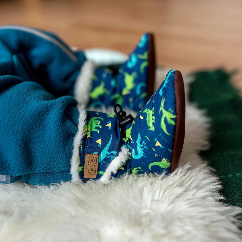 Jan & Jul Baby Stay-Put Winter Booties Space Dinos in blue with faux fur lining, snugly keeping tiny feet warm.