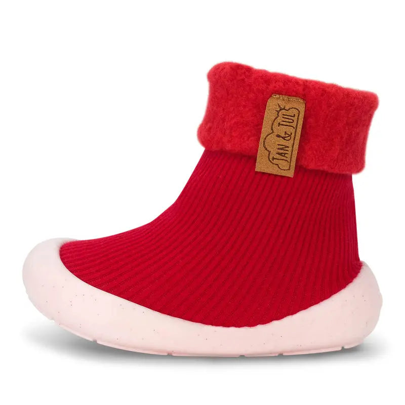 Jan & Jul Cozy Sock Shoes Red toddler sock shoe with white sole and folded cuff, brand tag visible.