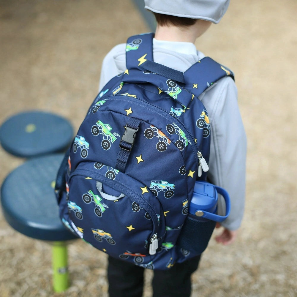 Jan & Jul Kids Backpack navy with monster-truck pattern and stars, worn by a child with a side water bottle holder.