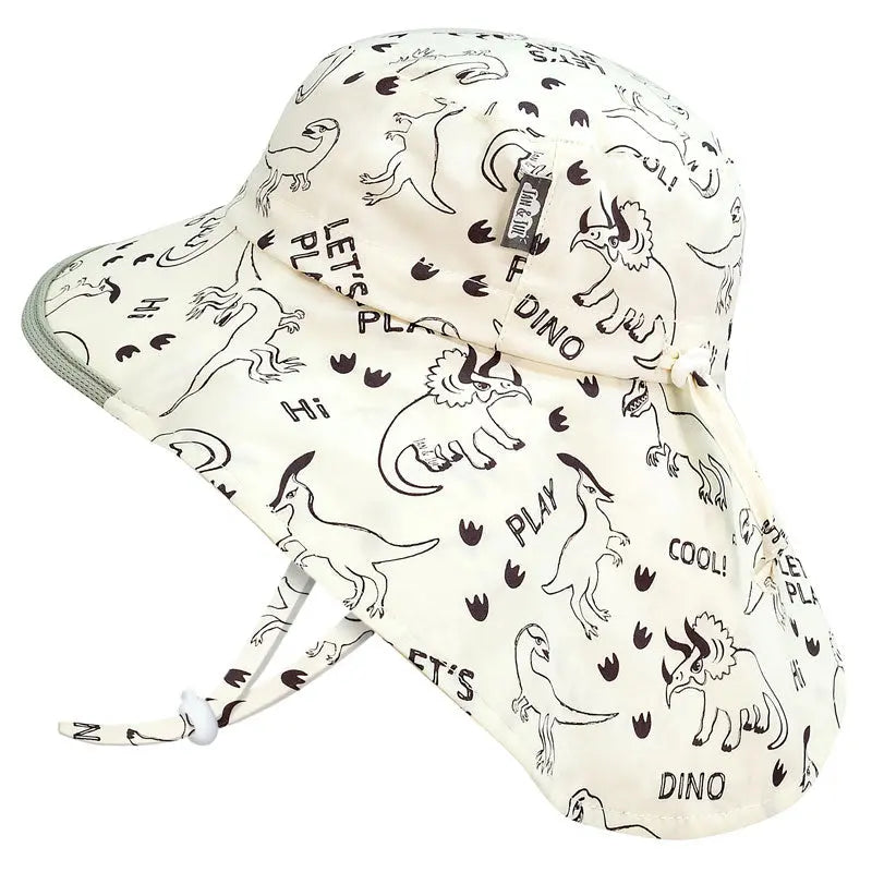 Jan & Jul Kids Cotton Adventure Hats Dino Play cream hat with chin strap and playful dinosaur print.