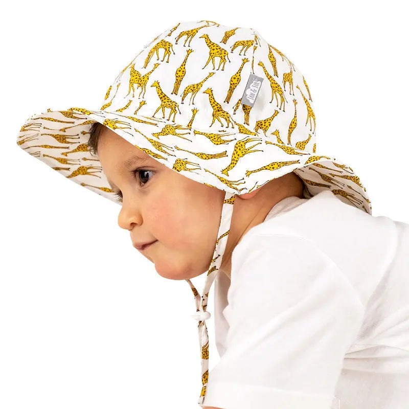 JAN & JUL Kids Cotton Floppy Hat Giraffe print on a toddler, wide brim with chin strap visible.