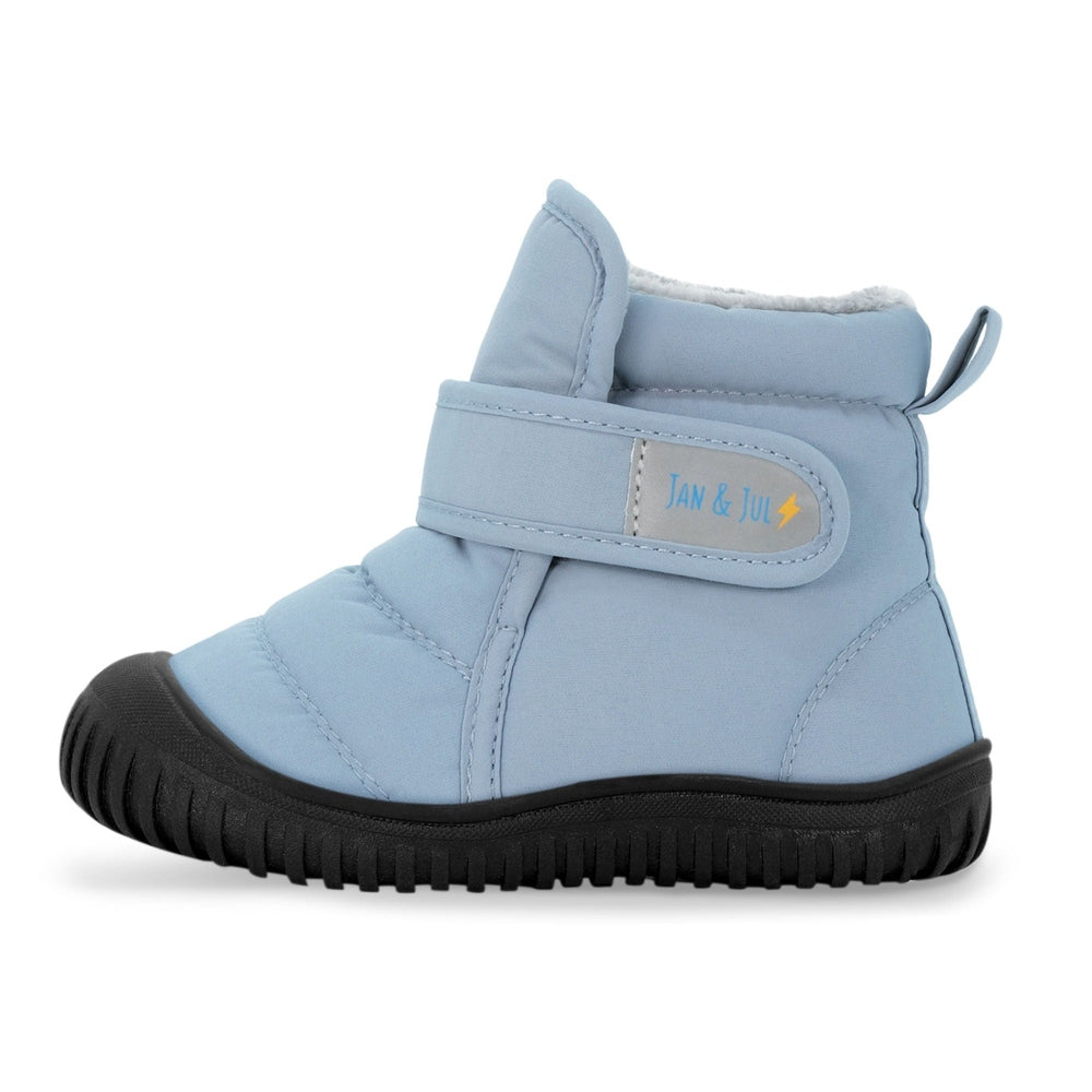 JAN & JUL Kids Insulated Ankle Boots in dusty blue with black lug sole, plush lining, strap fastened.
