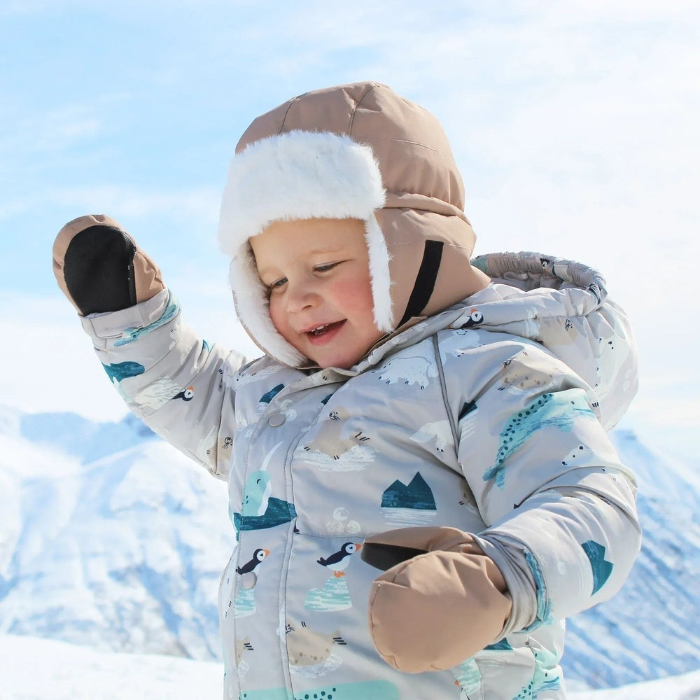 JAN & JUL Kids Insulated Winter Hat Soft Brown keeps little one cozy as toddler plays in snowy mountains.
