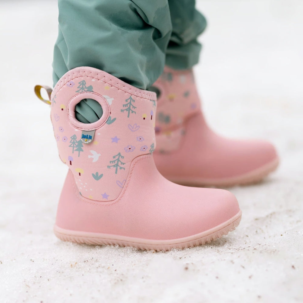 Jan & Jul Kids Lite Waterproof Boots Pink Forest; pink waterproof toddler boots with forest print worn by a child stepping in sand.