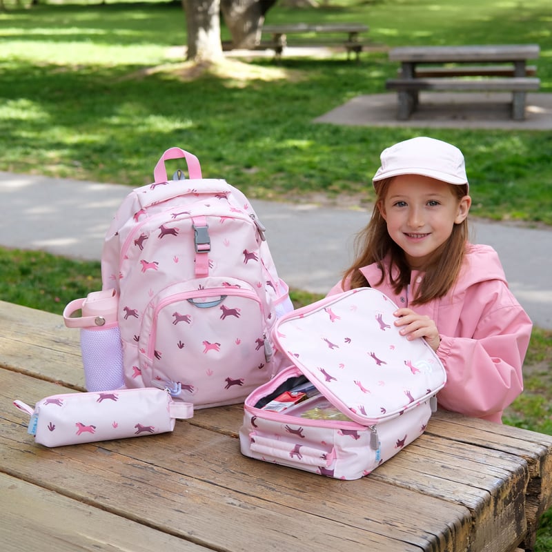 Jan & Jul Kids Lunch Bag Pink Ponies lifestyle photo with matching backpack