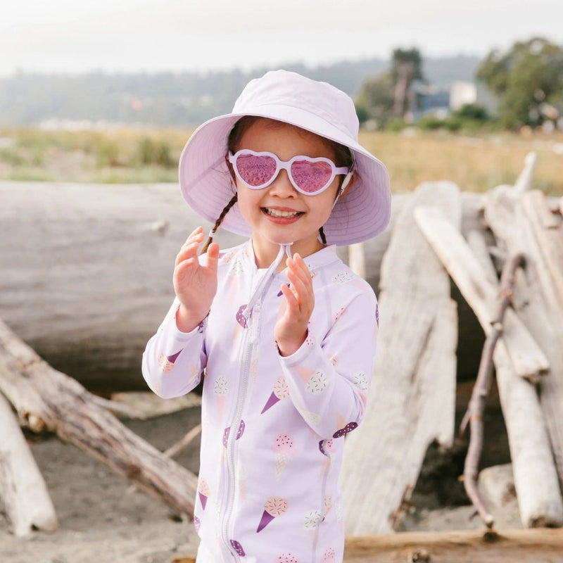 Jan & Jul kids polarized heart sunglasses lavender; child wearing lavender heart frames at the beach