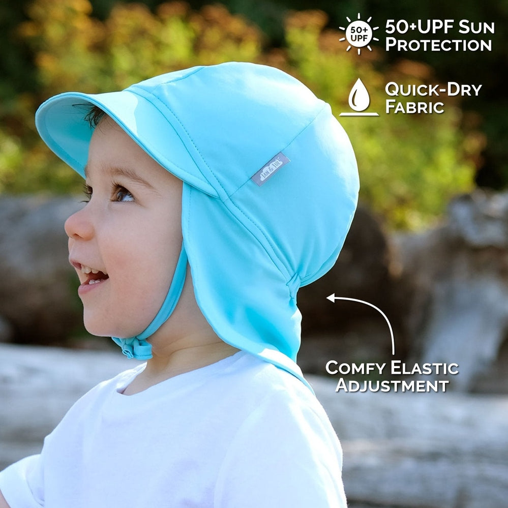 Jan & Jul Kids Sun Soft UV Baby Cap Blue Whale, worn by a smiling toddler; quick-dry fabric and comfy elastic adjustment.