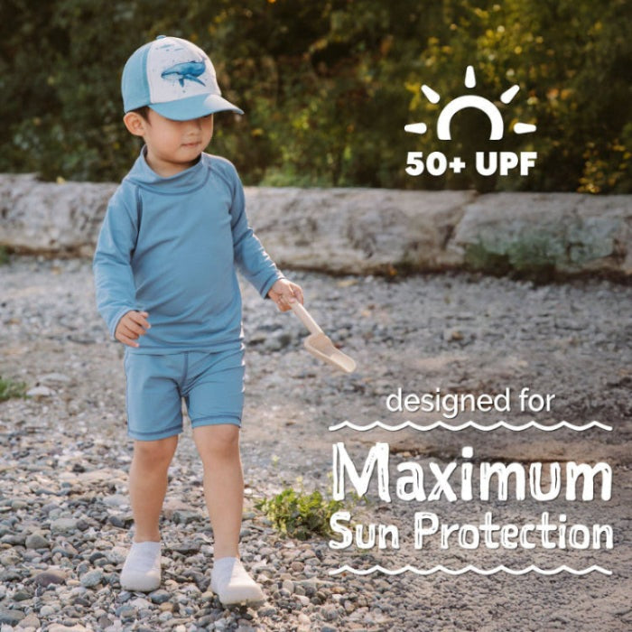 Jan & Jul Kids UV Rashguard Top Blue Grey worn by toddler on rocky shore, UPF 50+ sun protection.