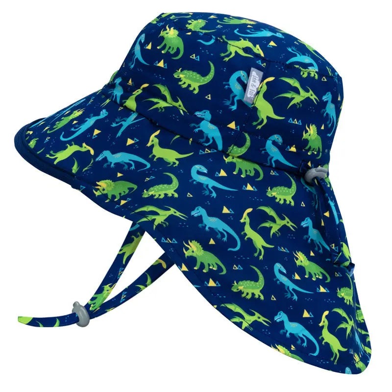 Jan & Jul Dinoland water-repellent adventure hat for kids, blue with green/cyan dinosaurs and adjustable chin strap.