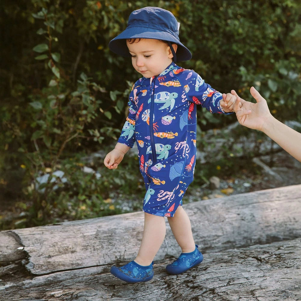 Jan & Jul Manta Ray kids water shoes in blue with flexible rubber sole worn by a toddler