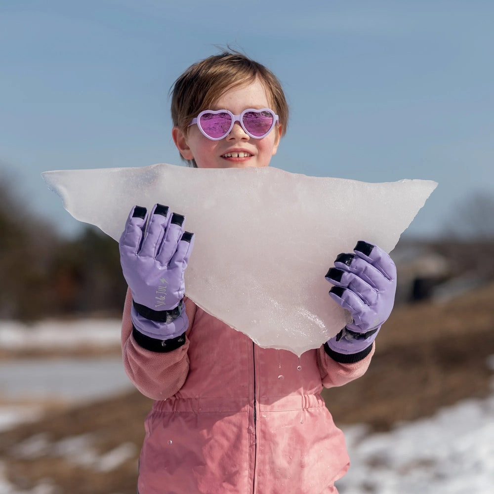 Jan & Jul Kids Waterproof Snow Gloves lavender, being held by a child in a pink jacket.